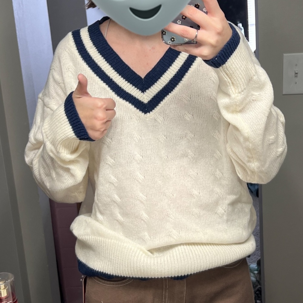 White knit sweater with blue collar and trim